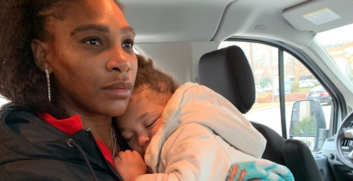 Serena Williams holding her sleeping toddler daughter in a car