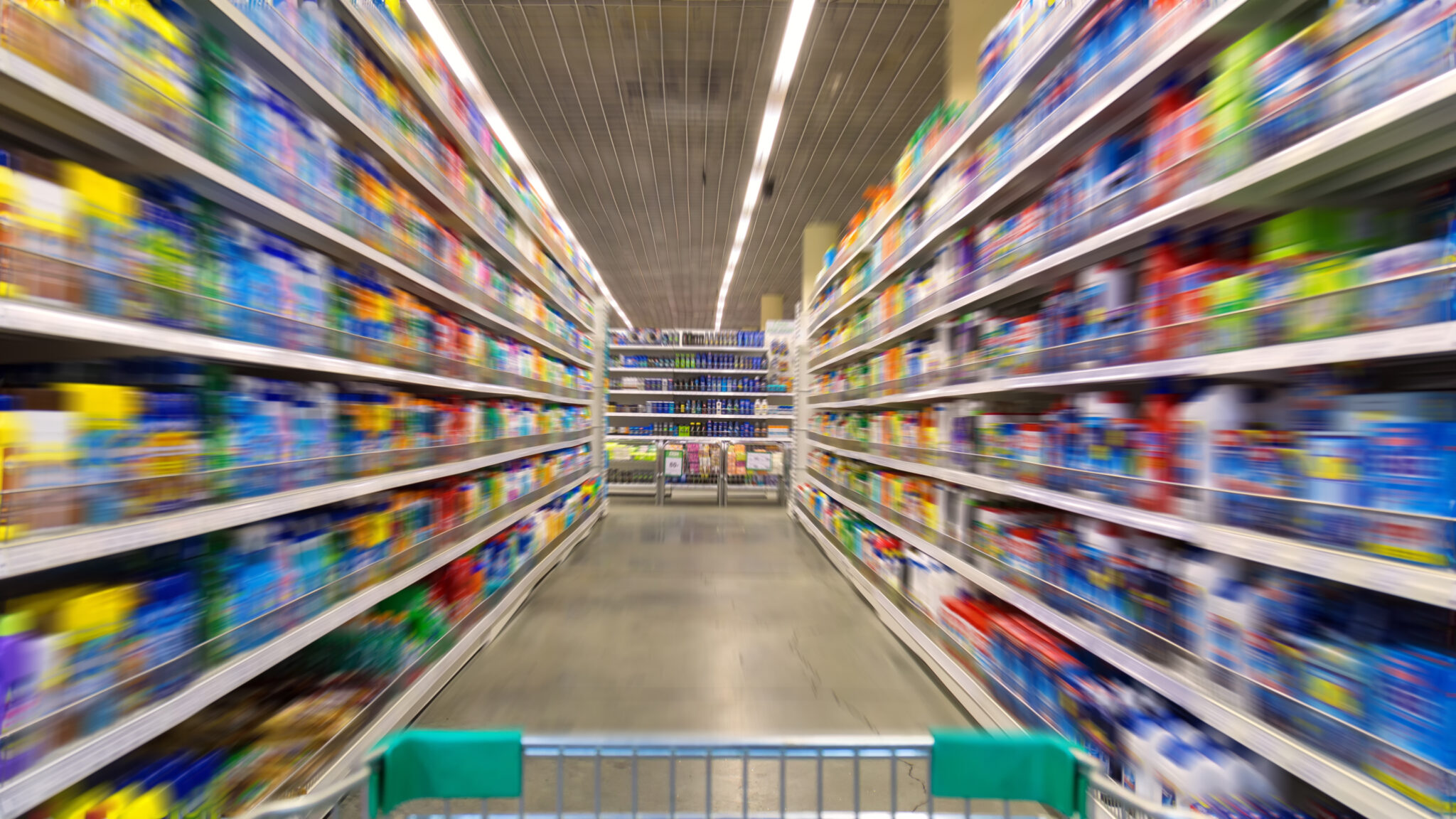 Shopping Cart View on a Supermarket Aisle and Shelves - Image Has a