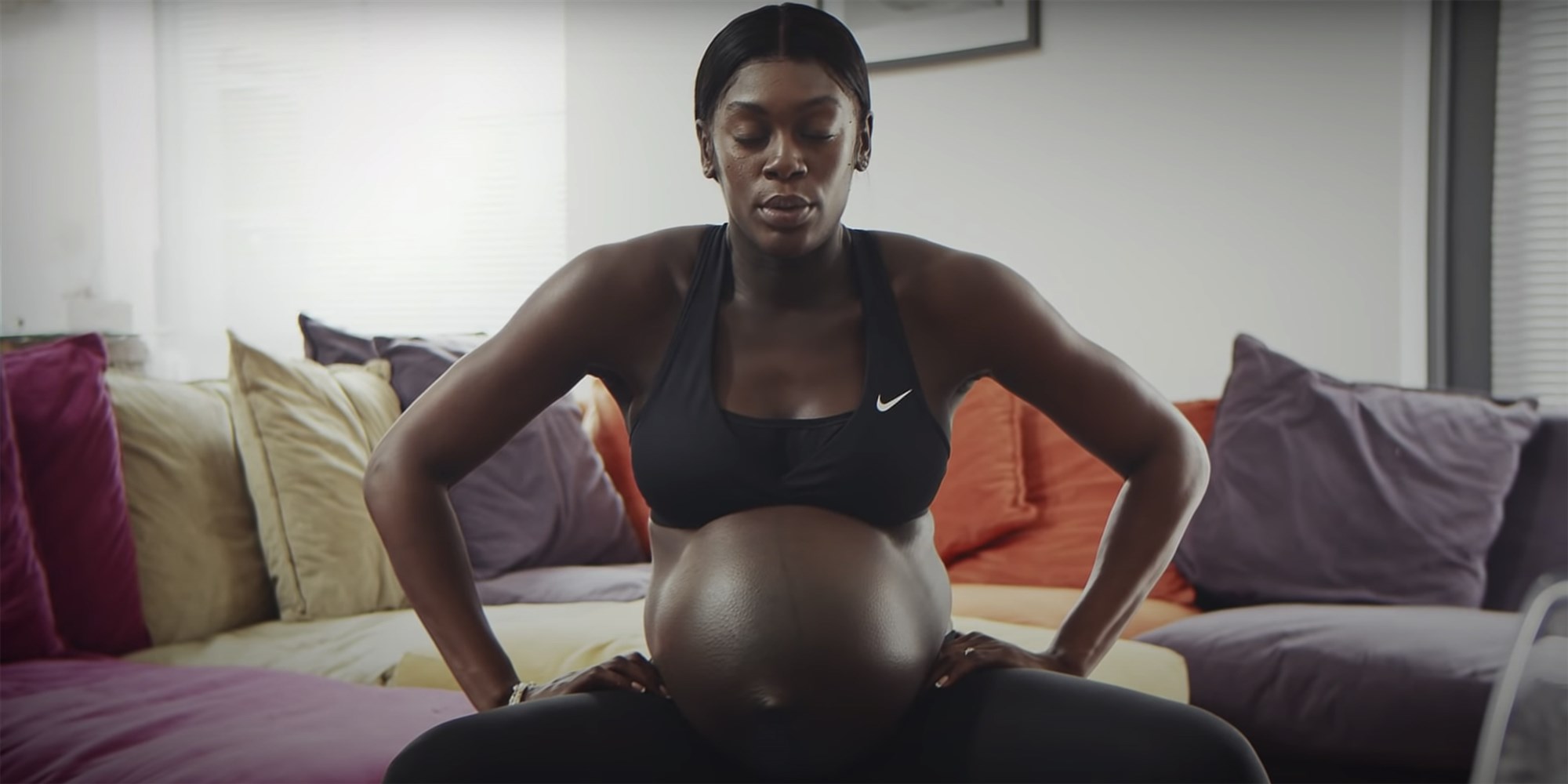 Pregnant athlete in a Nike sports bra breathing with eyes closed, from the commercial