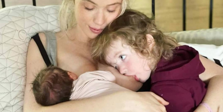 Laura Clery tandem nursing her newborn and her toddler son in bed